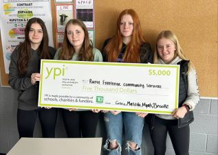 Students Cassie Tyron, Brooke Gunsinger, Matilda Price and Myah Crawford pose with a $5000 cheque addressed to Rural Frontenac Community Services.